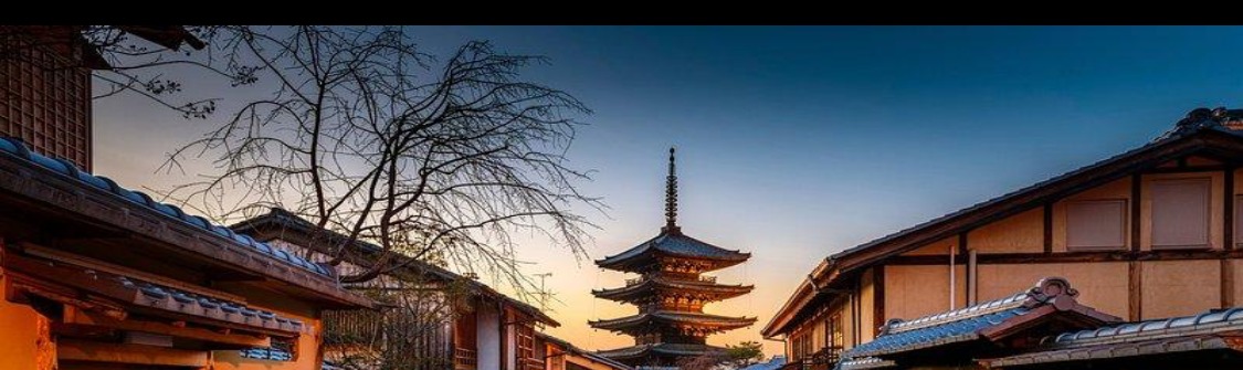 Kyoto at dusk with a five-story pagoda in the distance
